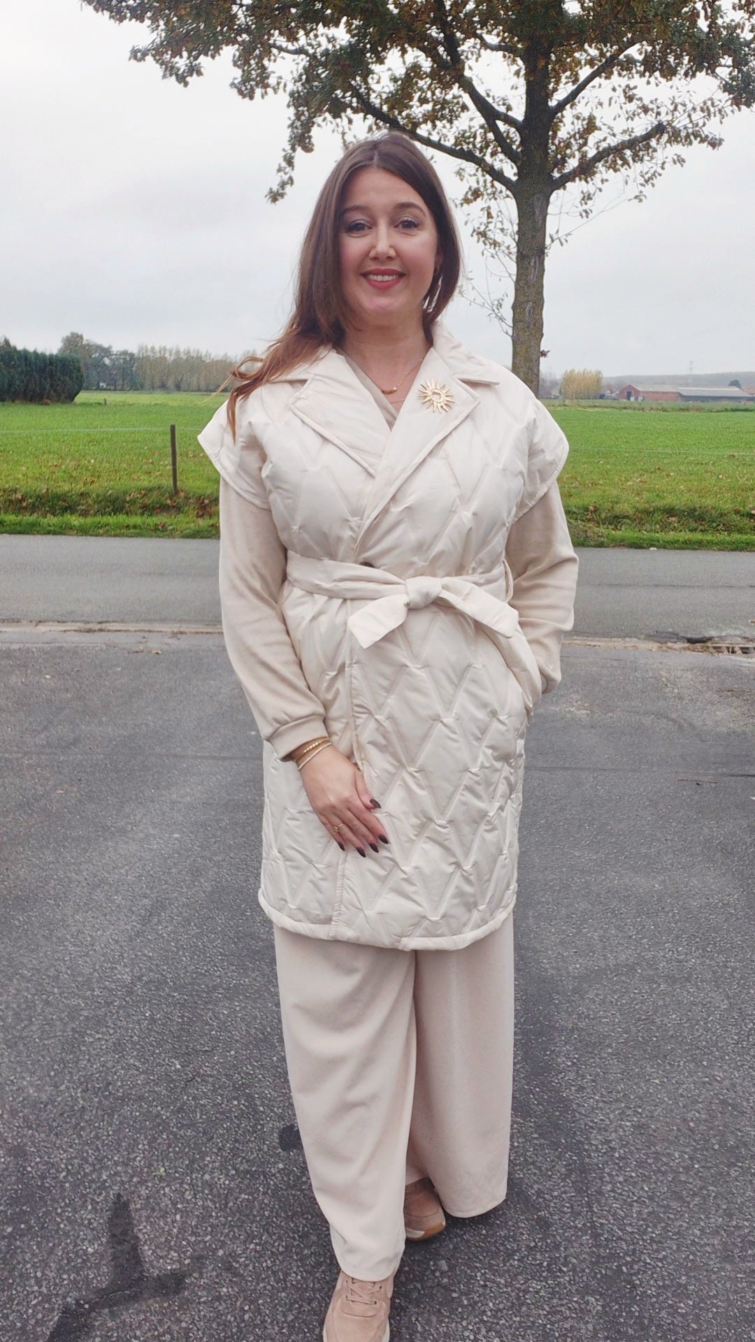 Lange bodywarmer met gouden broche - ecru